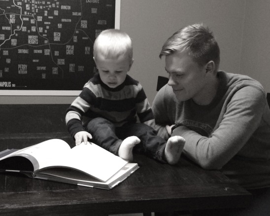 My husband and son, reading Unwrapping The Greatest Gift by Ann Voskamp